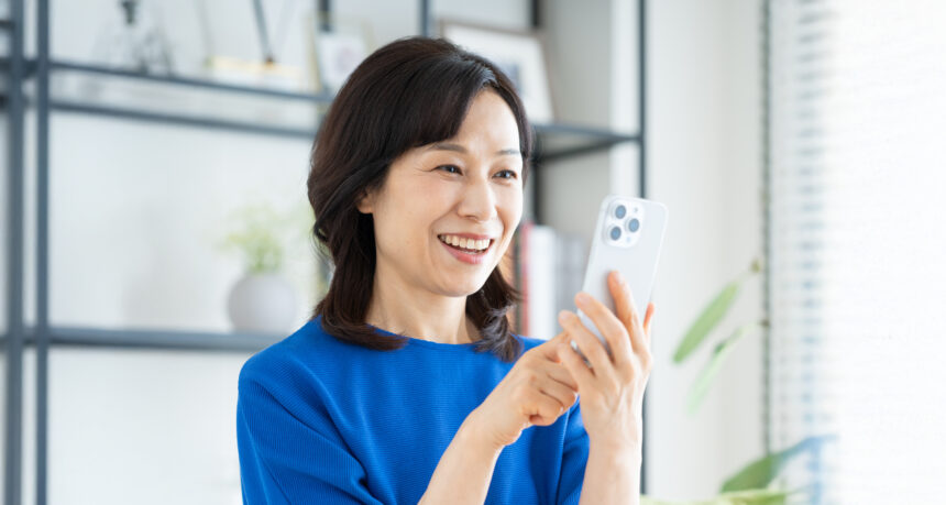 スマートフォンを楽しそうに見ている日本人女性